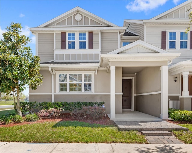 view of front of home featuring stucco siding and board and batten siding