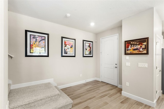 entrance foyer featuring light wood-style flooring and baseboards