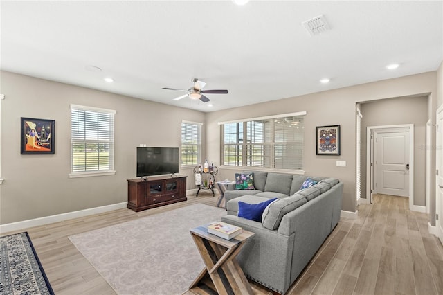 living room featuring visible vents, baseboards, recessed lighting, light wood-style flooring, and a ceiling fan