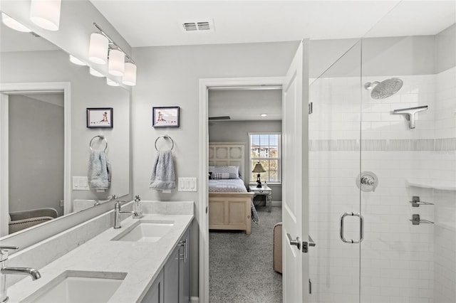 full bath featuring a sink, visible vents, a stall shower, and connected bathroom