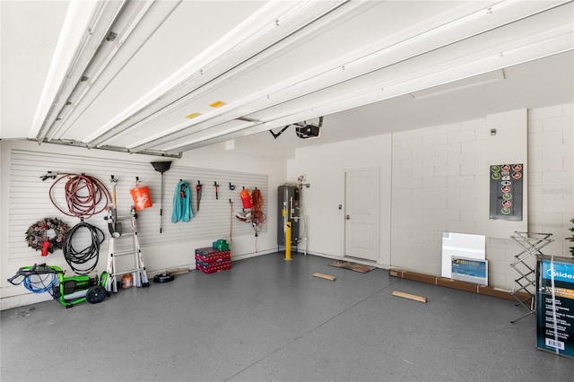 garage with concrete block wall, a garage door opener, and water heater