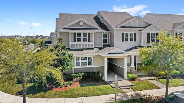 view of front of property featuring stucco siding, board and batten siding, and a shingled roof