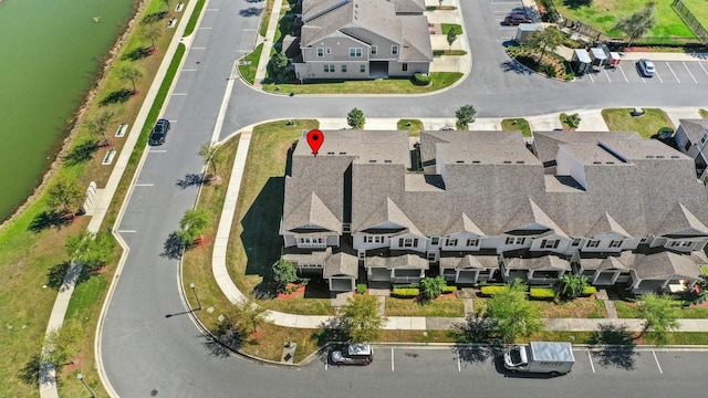 drone / aerial view featuring a residential view and a water view