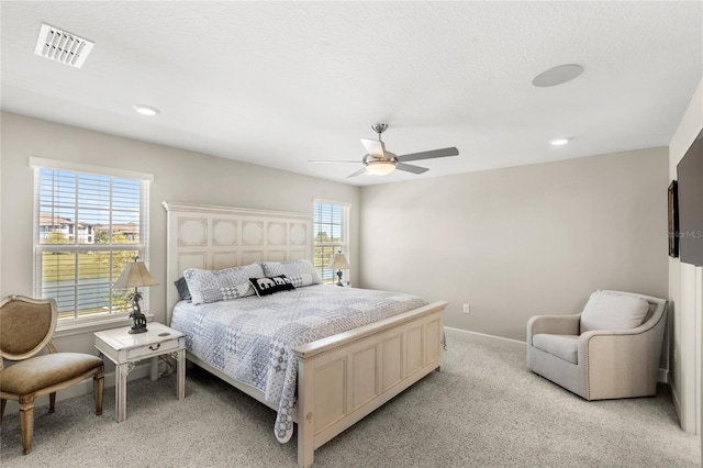 bedroom with visible vents, recessed lighting, baseboards, light colored carpet, and ceiling fan