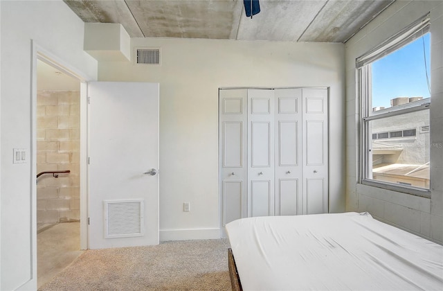 bedroom featuring a closet, visible vents, and carpet