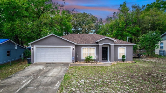 ranch-style home featuring stucco siding, a garage, roof with shingles, and concrete driveway