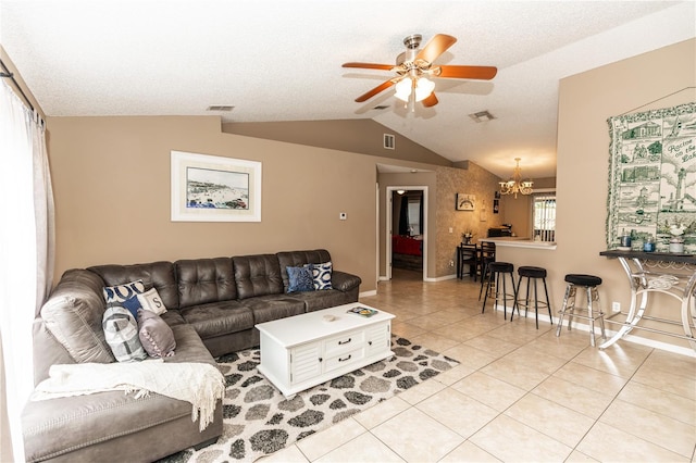 living room featuring light tile patterned flooring, visible vents, ceiling fan with notable chandelier, and vaulted ceiling