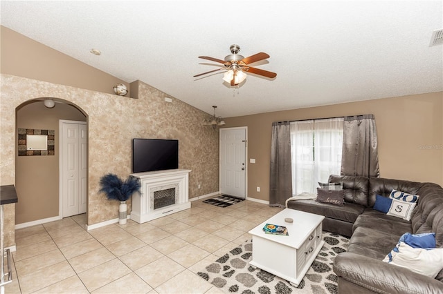 living room with vaulted ceiling, light tile patterned flooring, arched walkways, and ceiling fan