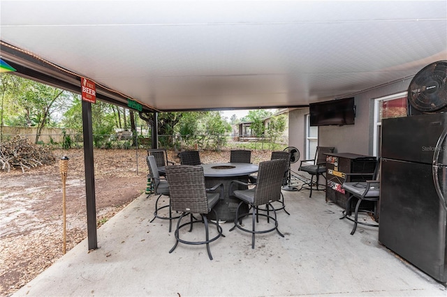 view of patio featuring outdoor dining space and fence