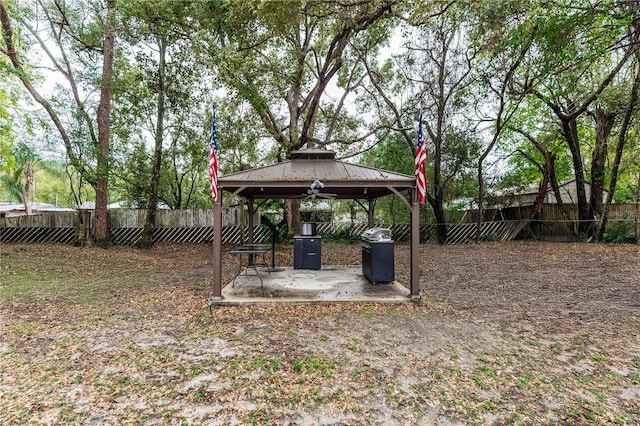 view of yard with a gazebo, a fenced backyard, and a patio area