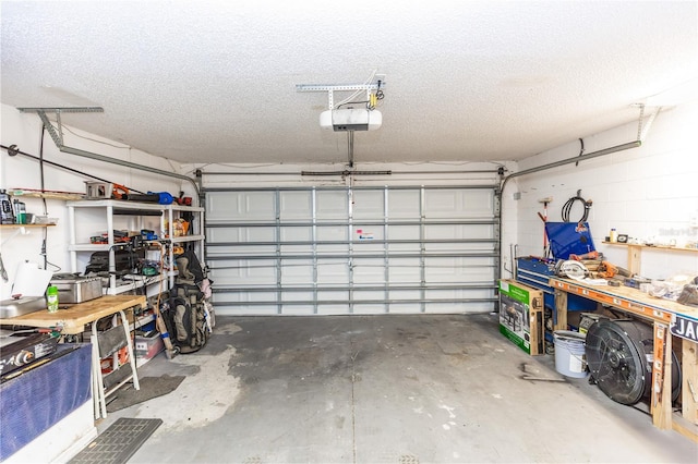 garage featuring a workshop area, concrete block wall, and a garage door opener