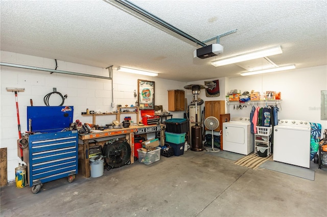 garage featuring washer and dryer, a workshop area, concrete block wall, and a garage door opener