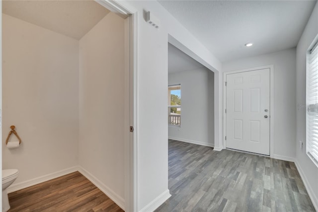 foyer featuring recessed lighting, wood finished floors, and baseboards