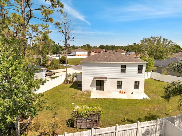 rear view of house with a patio, a fenced backyard, a lawn, and stucco siding