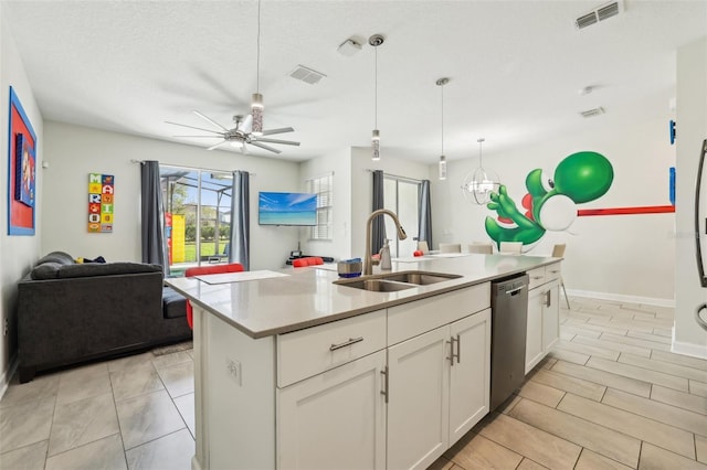 8959 Stinger Dr, Champions Gate, FL 33896 - kitchen featuring stainless steel dishwasher, open floor plan, white cabinets, light countertops, and a kitchen island with sink