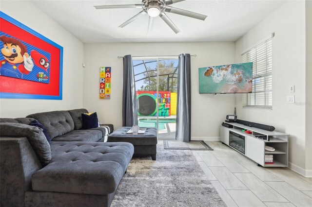 8959 Stinger Dr, Champions Gate, FL 33896 - living area with ceiling fan and plenty of natural light