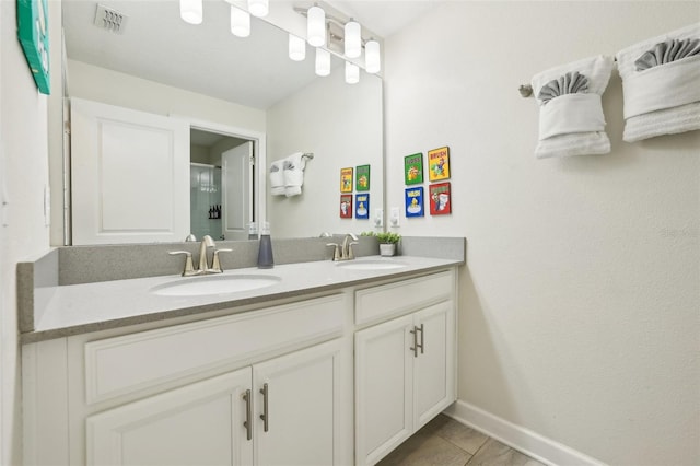 8959 Stinger Dr, Champions Gate, FL 33896 - full bath featuring double vanity, tile patterned floors, and an enclosed shower