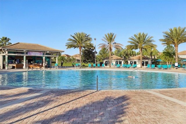 8959 Stinger Dr, Champions Gate, FL 33896 - community pool featuring a patio area