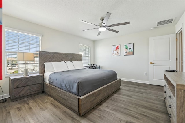8959 Stinger Dr, Champions Gate, FL 33896 - bedroom featuring wood finished floors, a ceiling fan, and a textured ceiling