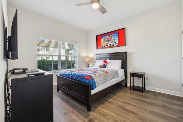 8959 Stinger Dr, Champions Gate, FL 33896 - bedroom with wood finished floors and a ceiling fan