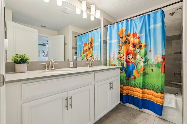 8959 Stinger Dr, Champions Gate, FL 33896 - full bathroom with double vanity, shower / bath combo, tile patterned flooring, and a textured ceiling