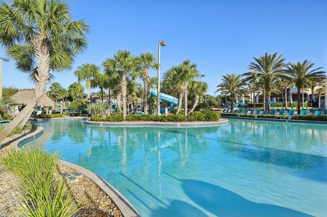 8959 Stinger Dr, Champions Gate, FL 33896 - community pool featuring a water slide