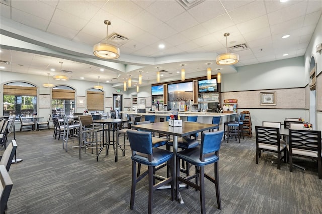 8959 Stinger Dr, Champions Gate, FL 33896 - dining area featuring dark colored carpet, recessed lighting, and a paneled ceiling