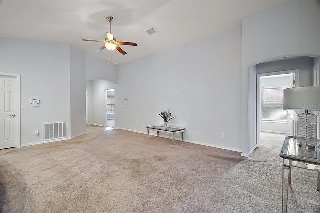 unfurnished living room featuring visible vents, high vaulted ceiling, carpet, and a ceiling fan