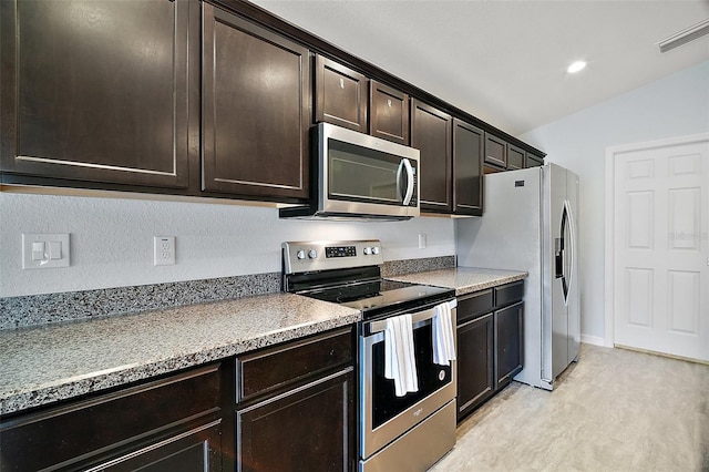 kitchen featuring baseboards, visible vents, lofted ceiling, stainless steel appliances, and dark brown cabinetry