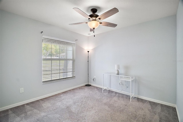 spare room with a ceiling fan, baseboards, and carpet floors
