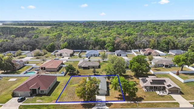 aerial view with a wooded view and a residential view