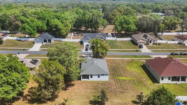 drone / aerial view featuring a view of trees and a residential view