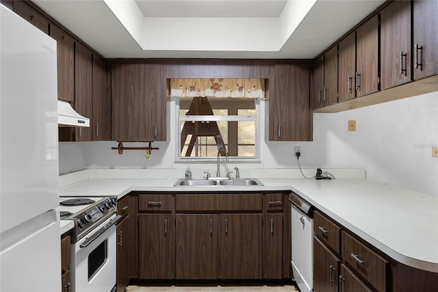 kitchen featuring a sink, white appliances, light countertops, and premium range hood