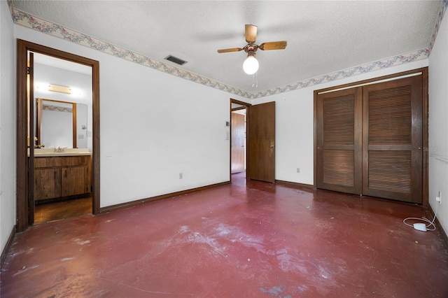 unfurnished bedroom featuring visible vents, a textured ceiling, and finished concrete floors