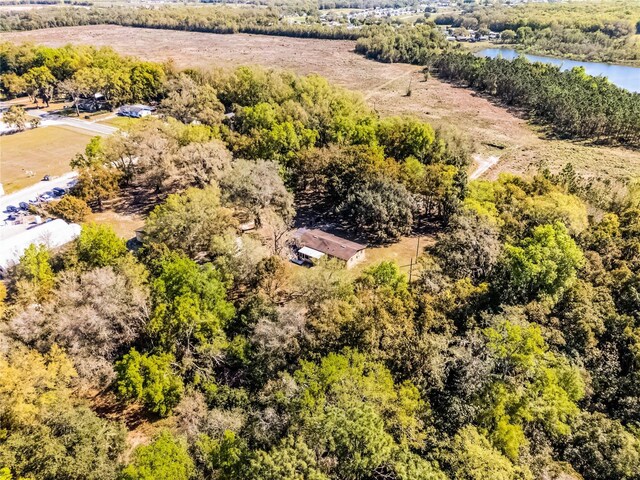 aerial view with a forest view and a water view