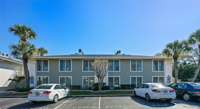 view of building exterior featuring uncovered parking