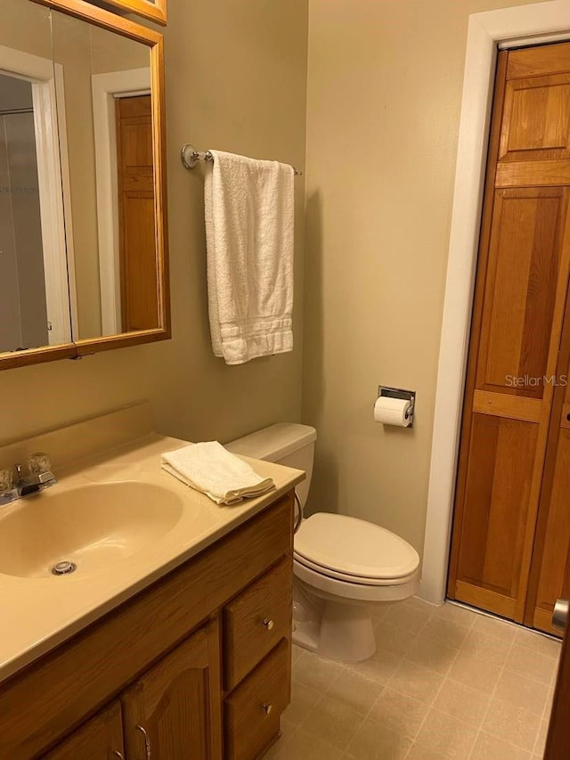 half bathroom with vanity and toilet