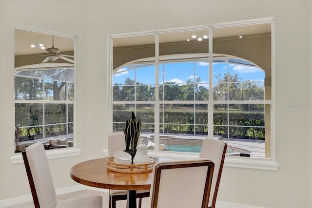 dining room featuring a ceiling fan and baseboards