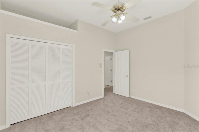 unfurnished bedroom featuring visible vents, ceiling fan, baseboards, carpet, and a closet