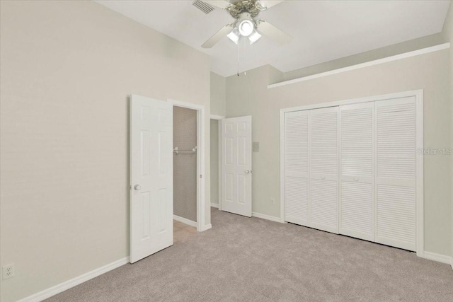 unfurnished bedroom with vaulted ceiling, carpet, baseboards, and a closet