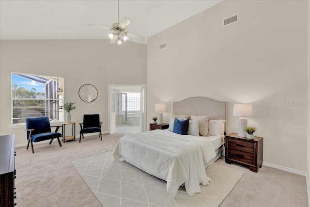 bedroom with high vaulted ceiling, baseboards, visible vents, and light carpet