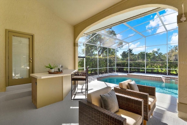 view of pool featuring a patio, a pool with connected hot tub, and a lanai