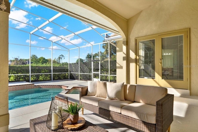 view of patio / terrace featuring glass enclosure, an outdoor pool, and an outdoor hangout area