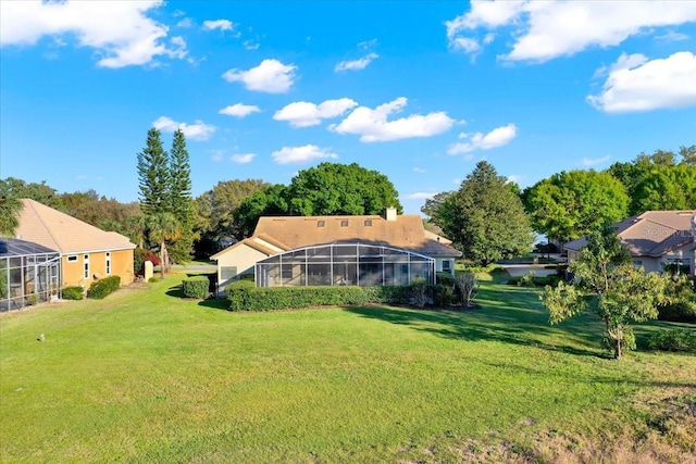 view of yard with glass enclosure