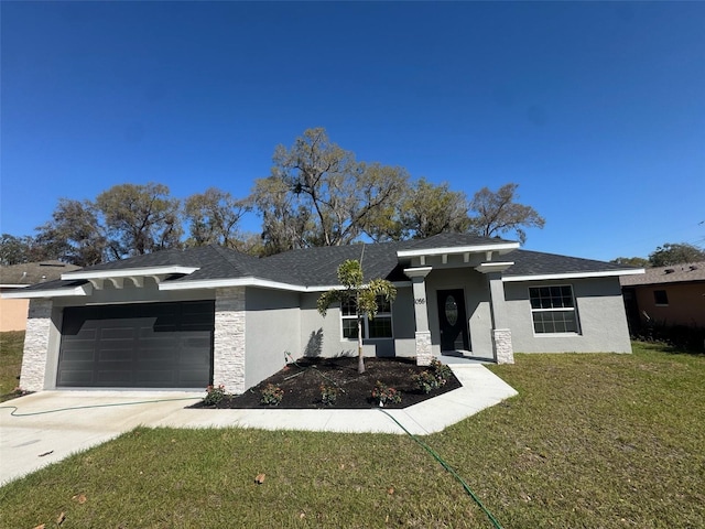 view of front of house featuring concrete driveway, a front yard, stucco siding, stone siding, and an attached garage