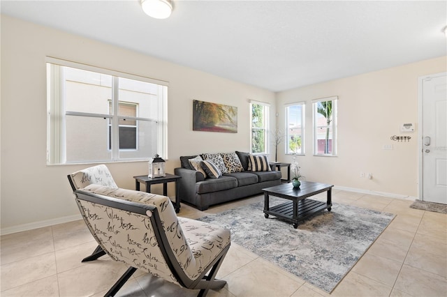 living area with light tile patterned floors and baseboards