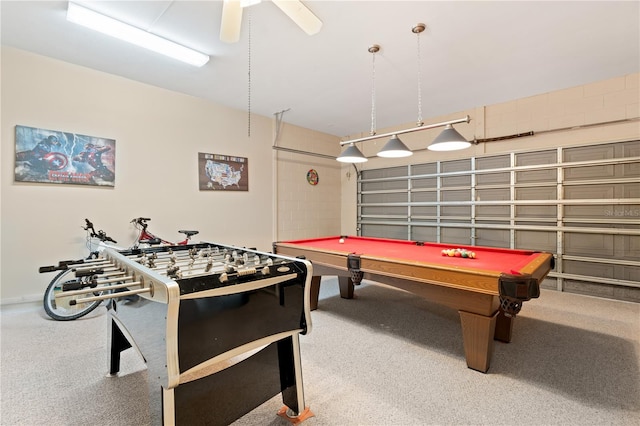 game room with carpet flooring, a garage, pool table, and a ceiling fan