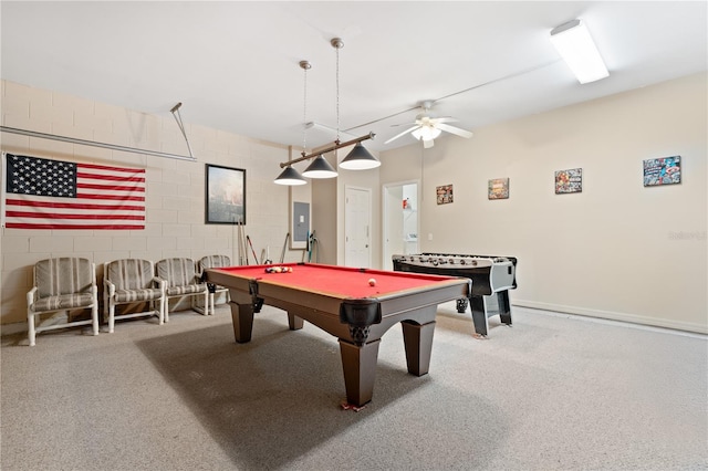 playroom with electric panel, carpet floors, a ceiling fan, and concrete block wall