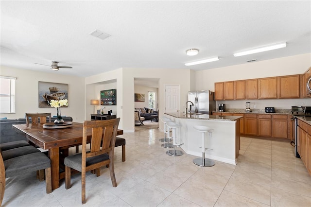 dining space with ceiling fan, light tile patterned floors, visible vents, and a textured ceiling