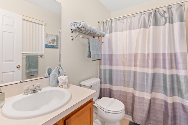 bathroom with vanity, a shower with shower curtain, and toilet